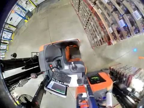 Forklift camera still: another forklift's rear against a parked stand-up forklift
