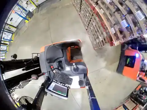 Forklift camera on a parked, empty stand-up forklift: another forklift reverses and its rear swings into it